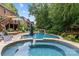 Beautiful backyard pool featuring a spa, waterfall and poolside seating provides a resort-like experience at 9513 Tresanton Dr, Charlotte, NC 28210