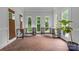 Bright sunroom featuring brick floors, neutral walls, and large windows perfect for a home office or study at 9513 Tresanton Dr, Charlotte, NC 28210