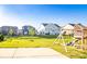 Wide backyard view showcasing a playground, patio and lush lawn at 9586 Kartey Nw Ave, Concord, NC 28027