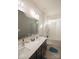 Bright bathroom featuring double sinks, large mirror, shower with tub, and neutral-colored walls at 9586 Kartey Nw Ave, Concord, NC 28027
