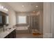 Inviting bathroom featuring soaking tub with tiled surround, and a separate glass-enclosed shower at 9586 Kartey Nw Ave, Concord, NC 28027
