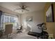 Bright bedroom with a ceiling fan, large window, desk, and treadmill, perfect for a home office at 9586 Kartey Nw Ave, Concord, NC 28027
