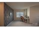 Upstairs bonus room with accent wall and a desk area at 9586 Kartey Nw Ave, Concord, NC 28027