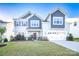Charming two-story home featuring a manicured lawn, two car garage and tasteful landscaping at 9586 Kartey Nw Ave, Concord, NC 28027