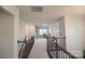 Hallway with an open view of the downstairs bonus room with staircase railing at 9586 Kartey Nw Ave, Concord, NC 28027