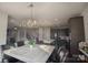 Open concept kitchen with stainless steel appliances, island, and dining area with decorative light fixtures at 9586 Kartey Nw Ave, Concord, NC 28027