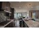 Open-concept kitchen featuring dark cabinets, stainless steel appliances, and an island at 9586 Kartey Nw Ave, Concord, NC 28027