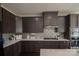 Modern kitchen featuring dark cabinetry, stainless steel appliances, and quartz countertops at 9586 Kartey Nw Ave, Concord, NC 28027