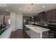 Stylish kitchen with dark cabinetry, stainless steel appliances, and breakfast bar at 9586 Kartey Nw Ave, Concord, NC 28027
