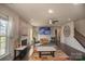 Cozy living room with stone fireplace, comfortable seating, and a ceiling fan for added comfort at 9586 Kartey Nw Ave, Concord, NC 28027