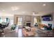 Spacious living room featuring fireplace, large windows, with an open floor plan to kitchen and dining area at 9586 Kartey Nw Ave, Concord, NC 28027