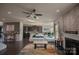 Bright living room featuring stone accent wall with fireplace and stylish decor, open to dining and kitchen at 9586 Kartey Nw Ave, Concord, NC 28027