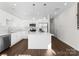 A contemporary kitchen with white cabinets, an island, stainless steel appliances, and stylish pendant lighting at 9713 Misenheimer Rd # 4A, Charlotte, NC 28215