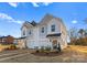 New townhome construction with attached garages, landscaped front yards, and attractive architectural details on a sunny day at 9715 Misenheimer Rd # 4B, Charlotte, NC 28215