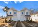 New construction townhomes showcase modern architectural details, attached garages, and landscaped front yards on a sunny day at 9715 Misenheimer Rd # 4B, Charlotte, NC 28215