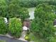 Home nestled amongst trees with a driveway and a pond nearby at 1021 Stinson Glen Ln, Charlotte, NC 28214