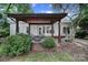 A covered patio features outdoor seating, a fire pit, and a view of the landscaped backyard at 1021 Stinson Glen Ln, Charlotte, NC 28214