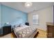 Comfortable bedroom features hardwood floors, neutral decor, and a decorative accent wall at 1021 Stinson Glen Ln, Charlotte, NC 28214