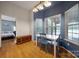 Bright dining area features natural light, a wood bench, and blue accent wall at 1021 Stinson Glen Ln, Charlotte, NC 28214
