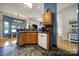 Well-lit kitchen area with stone tile floors, wood cabinets, and stylish pendant lighting at 1021 Stinson Glen Ln, Charlotte, NC 28214