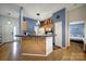 Charming kitchen with wood cabinetry, a tile backsplash, and a unique breakfast bar at 1021 Stinson Glen Ln, Charlotte, NC 28214