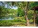 Scenic view of a lake surrounded by lush greenery, offering a peaceful natural setting at 1021 Stinson Glen Ln, Charlotte, NC 28214