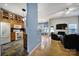 Open-concept living space with kitchen view, dining area, hardwood floors, and modern decor at 1021 Stinson Glen Ln, Charlotte, NC 28214