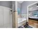 Relaxing main bath showcases a soaking tub, a walk-in shower and blue accents at 1021 Stinson Glen Ln, Charlotte, NC 28214