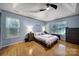 Cozy main bedroom featuring hardwood floors, vaulted ceiling, and natural light at 1021 Stinson Glen Ln, Charlotte, NC 28214
