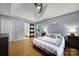 Spacious main bedroom with hardwood floors, tray ceiling, and sliding barn door to the ensuite bath at 1021 Stinson Glen Ln, Charlotte, NC 28214