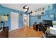 Bright office space boasts hardwood floors, blue walls, ceiling fan and custom shelving at 1021 Stinson Glen Ln, Charlotte, NC 28214