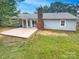 Backyard featuring a concrete patio and spacious lawn, perfect for outdoor activities and entertaining at 10701 Copper Field Dr, Pineville, NC 28134