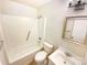 Clean bathroom with a shower-tub combo, white fixtures, and a vanity with a framed mirror at 10701 Copper Field Dr, Pineville, NC 28134