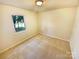 Well-lit bedroom with neutral walls and carpet flooring at 10701 Copper Field Dr, Pineville, NC 28134