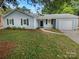 Charming single-story home with light blue siding, black shutters, and a well-maintained front yard at 10701 Copper Field Dr, Pineville, NC 28134