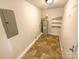 Utility room with a water heater, shelving, and practical flooring at 10701 Copper Field Dr, Pineville, NC 28134