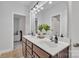 Modern bathroom with double sinks, large mirror, and decorative plant, plus views into the other rooms at 11224 Warfield Ave, Huntersville, NC 28078