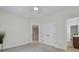 Neutral bedroom features two doorways, a closet, and neutral colored walls and carpet at 11224 Warfield Ave, Huntersville, NC 28078