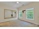 A bright bedroom features two windows, a large mirror, neutral walls, and a ceiling fan at 11224 Warfield Ave, Huntersville, NC 28078