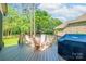 Spacious wooden deck with outdoor seating and a grill, perfect for entertaining and enjoying the serene backyard at 11224 Warfield Ave, Huntersville, NC 28078