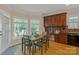 Bright dining area with table, chairs, and sunlit windows overlooking the backyard at 11224 Warfield Ave, Huntersville, NC 28078