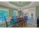 Spacious dining room with stylish lighting, windows and hardwood floors with elegant table at 11224 Warfield Ave, Huntersville, NC 28078