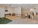 A large game room with golf simulator, sitting area, entertainment area, and stairs at 11224 Warfield Ave, Huntersville, NC 28078