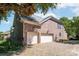 Spacious two-car garage and brick driveway, complemented by well-maintained landscaping at 11224 Warfield Ave, Huntersville, NC 28078