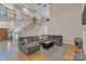 Bright living room with hardwood floors, fireplace, and large gray sectional couch at 11224 Warfield Ave, Huntersville, NC 28078