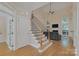 Bright living room features wood floors, fireplace, and staircase with iron balusters at 11224 Warfield Ave, Huntersville, NC 28078