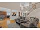 Spacious living room featuring a gray sectional couch, fireplace, and hardwood flooring at 11224 Warfield Ave, Huntersville, NC 28078