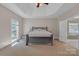 Bright main bedroom features tray ceilings, neutral walls, carpet floors and an ensuite bathroom at 11224 Warfield Ave, Huntersville, NC 28078