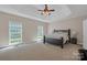 Bright main bedroom features tray ceilings, neutral walls, carpet floors, and large windows offering natural light at 11224 Warfield Ave, Huntersville, NC 28078