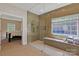 The tiled glass-enclosed shower includes a window, tiled bench, and shower head at 11224 Warfield Ave, Huntersville, NC 28078